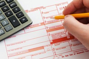 Form 1099-MISC for 2010 with calculator and pencil on it