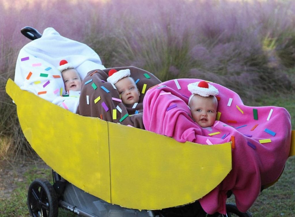 infant triplets dressed up as scoops of ice cream sitting in a triplet stroller that looks like a banana split