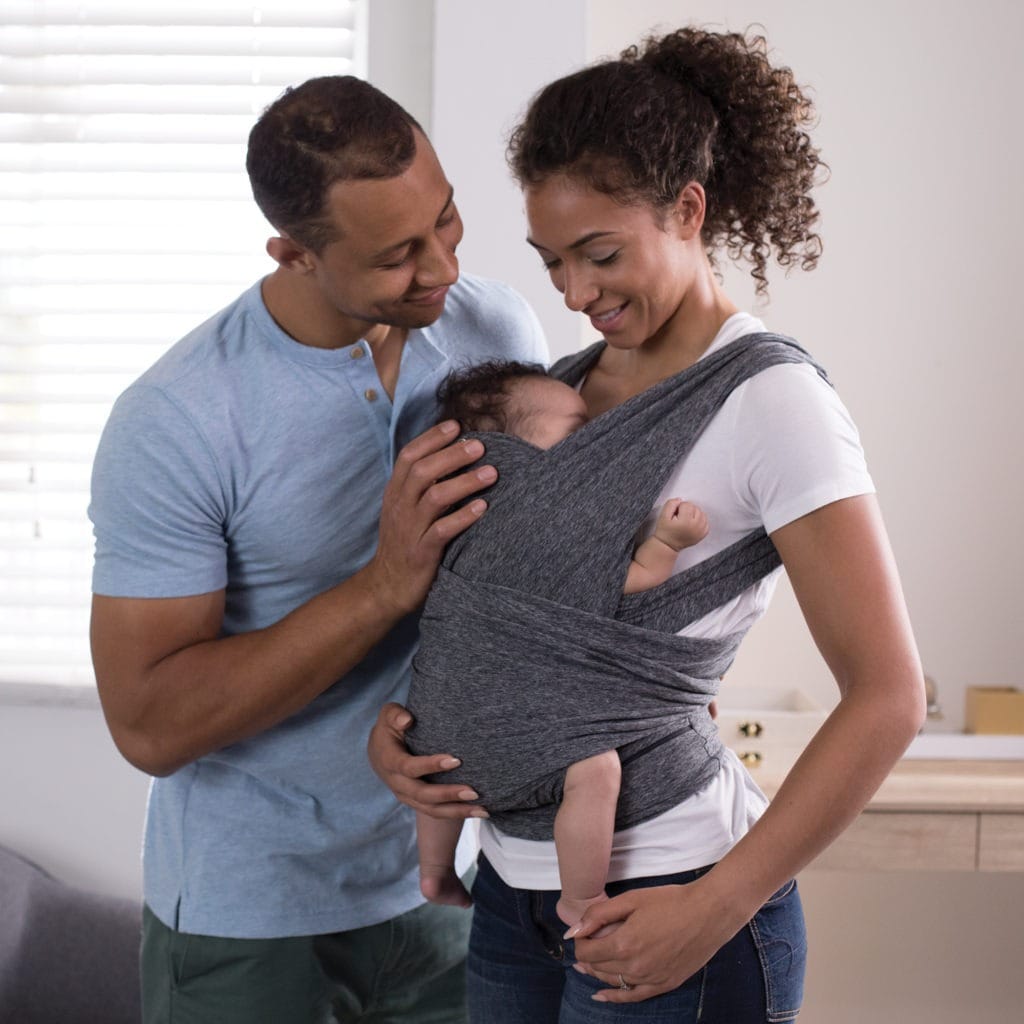 mom and dad with baby in carrier truth about babywearing