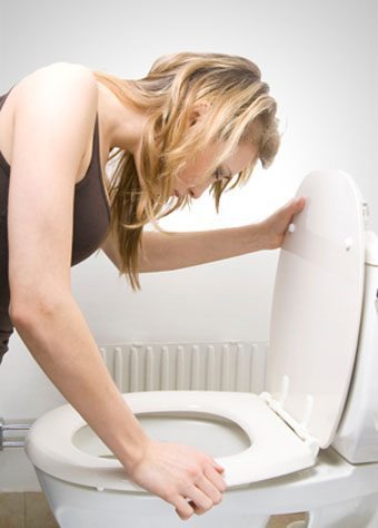 pregnant woman sick over toilet