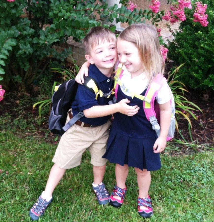 5 year old boy girl twins hugging wearing backpacks newborn twins