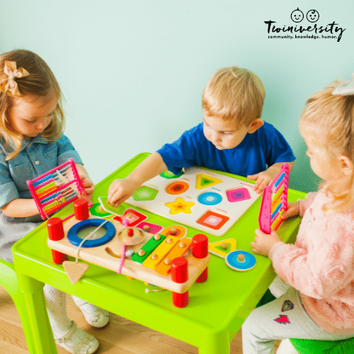 children playing at a table at a daycare for twins