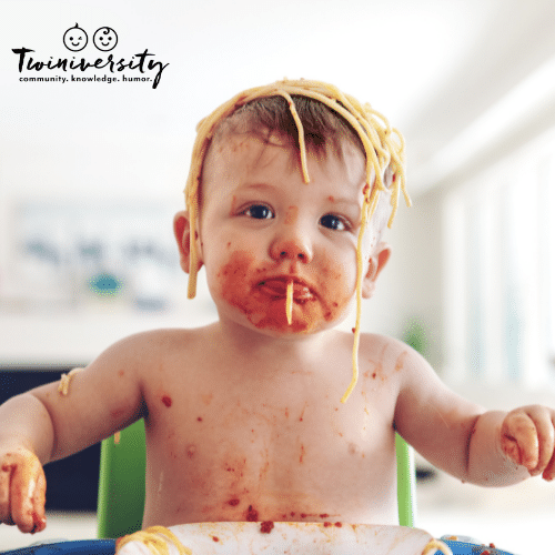 baby eating spaghetti and making a big mess