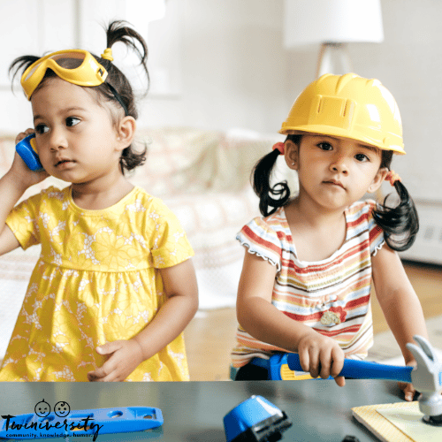 twin toddlers play dress up and tools