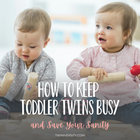 twin toddlers keep busy playing with blocks