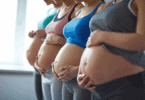 4 pregnant women holding their pregnant bellies