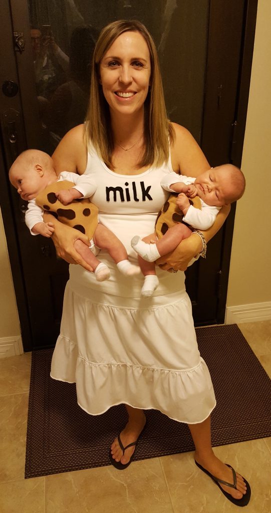 new mom of twins wearing a milk t-shirt holding newborn twins dressed as chocolate chip cookies