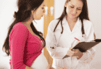 a woman asks her doctor questions during a prenatal exam