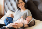 a woman holds twins in bed