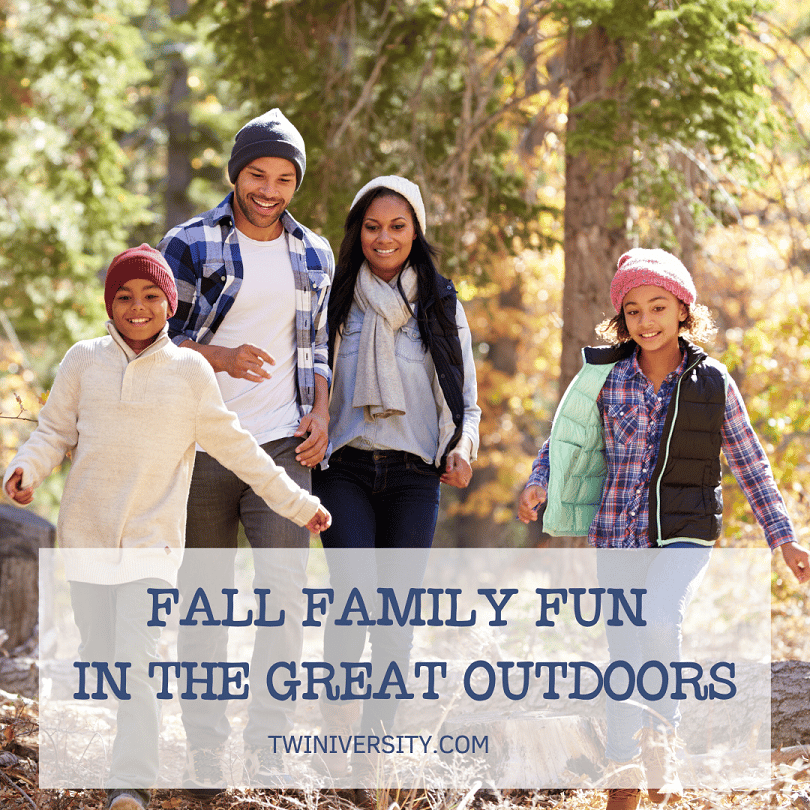 a family has fun outdoors in the fall walking in the woods