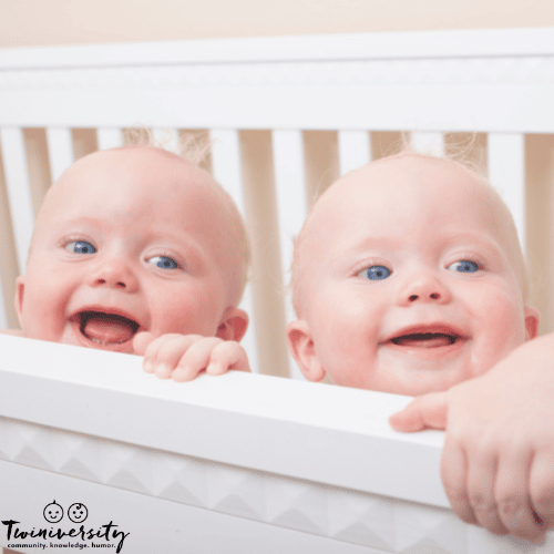 identical twin babies in a crib