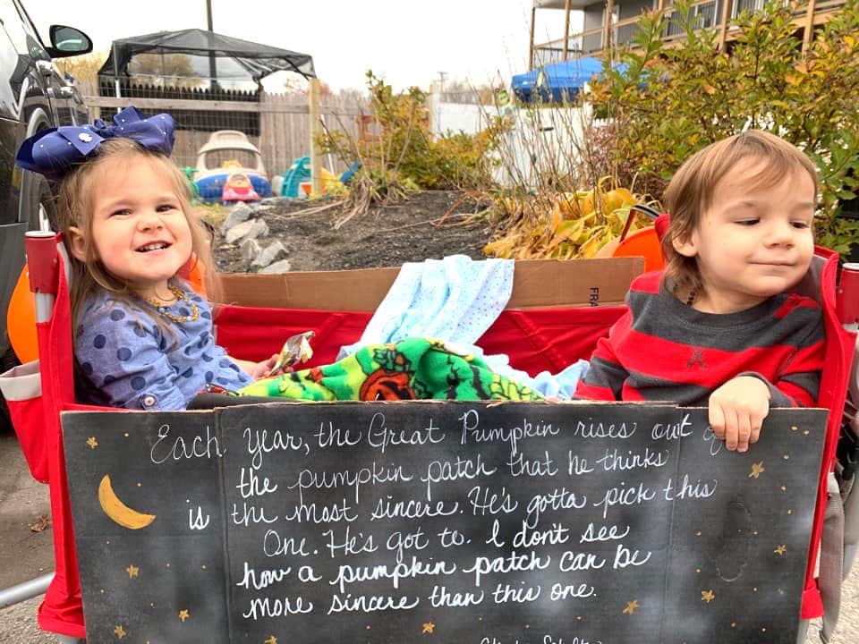 twins sitting in a wagon dressed up like sally and linus waiting for the great pumpkin