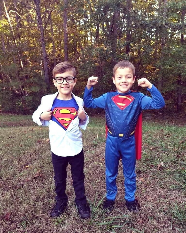 identical twin boys dressed up like superman and clark kent