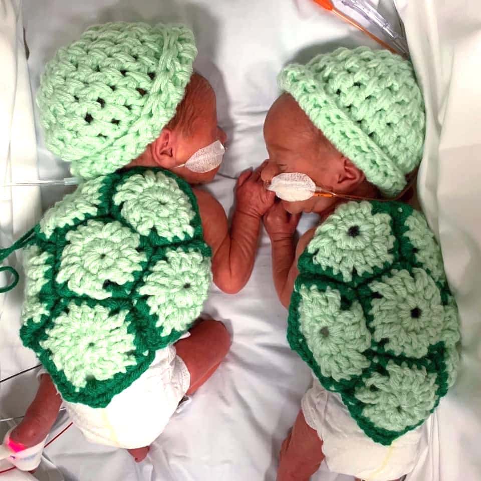 twin preemie babies in the NICU dressed up like turtles