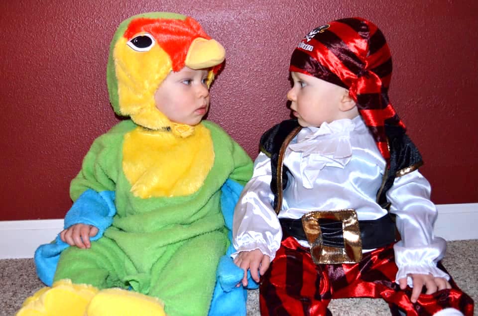 twin boys dressed up as a pirate and a parrot