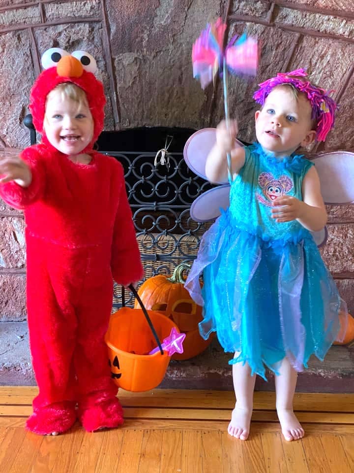 twin toddlers dressed up as elmo and abby caddaby from sesame street