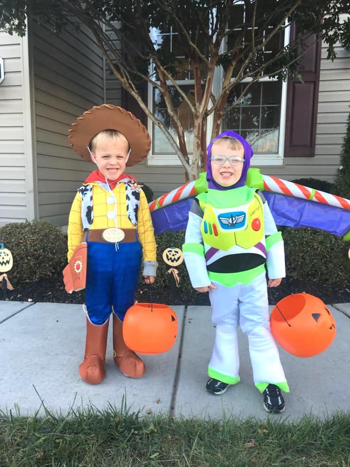 twin boys dressed up as buzz and woody from toy story