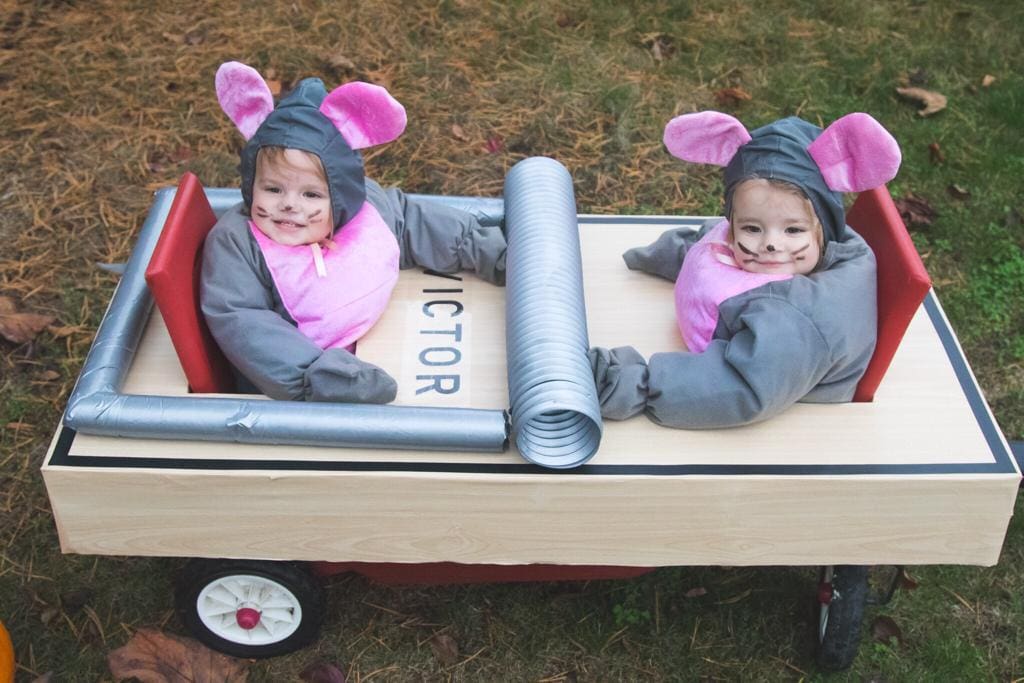 twin girls dressed as mice in a wagon dressed as a mouse trap twin girls halloween costumes