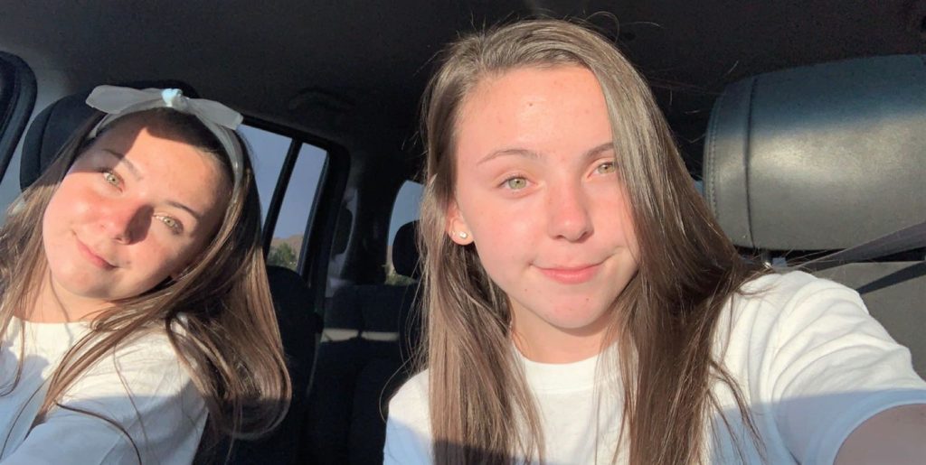 teen driver twins in the front seat together