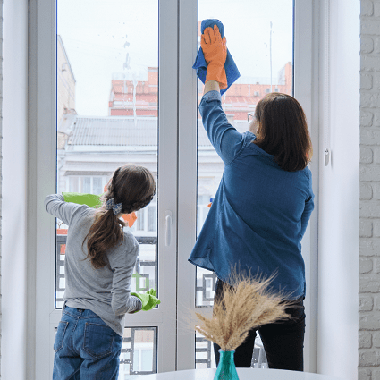 chores for 6-year-olds a woman and child cleaning glass windows side by side with rages and gloves on