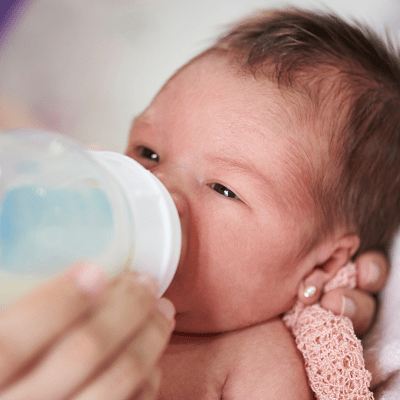 how many baby bottles do i need  Newborn baby eating from a bottle