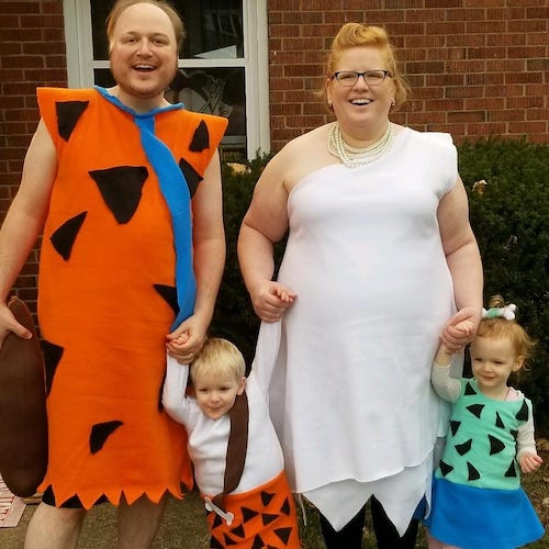 family dressed as the Flintstones boy girl twin halloween costumes