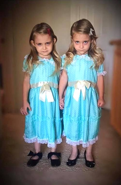 twin girls dressed as the twins from movie The Shining twin girls halloween costumes