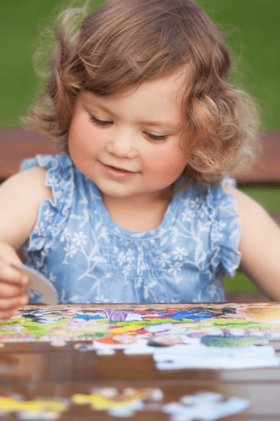 play centers girls doing puzzle on table