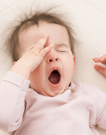 toddler bed for twins toddler yawning and rubbing eyes while laying down