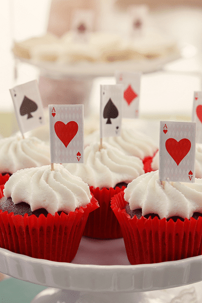 twins' birthday chocolate cupcakes in red paper with frosting and cards on top