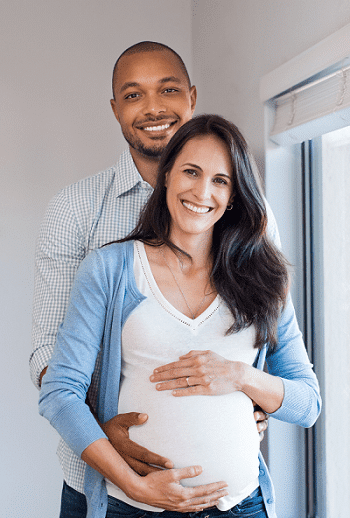 pregnant woman and partner holding her belly