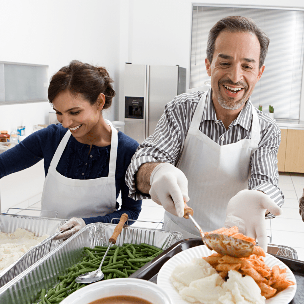 leftover Halloween candy a man serving pasta and a woman smiling and stirring potatoes in a kitchen