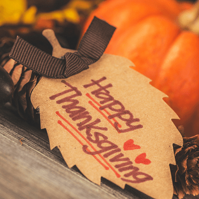 thanksgiving dinner tag and pumpkin on a table