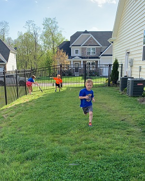 physical activities 2 boys running in grass yard