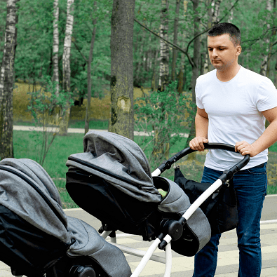 newborn twins stroller man walking with a double stroller