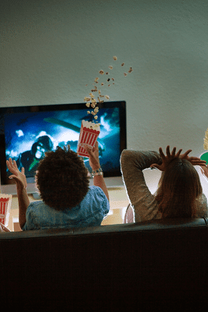 kids watching tv covering their eyes and holding popcorn
halloween movies on netflix for kids