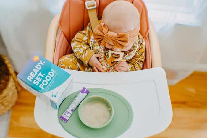 baby in a high chair with bowl ready set food allergies for babies
