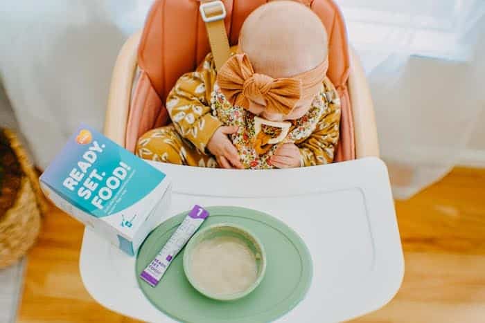 baby in a high chair with bowl ready set food allergies for babies