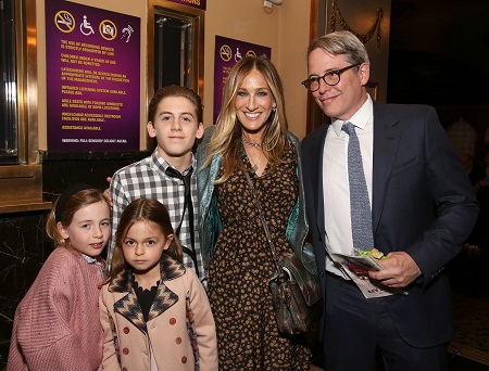 celebrities with twins famous family photo outside a theater. All 5 are looking at the cameras