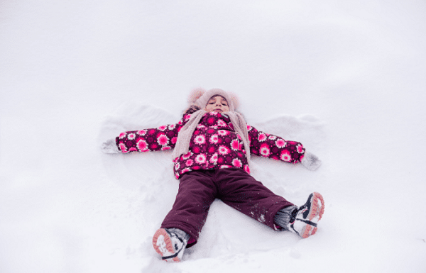 toddler snow boots Girl laying in the snow with a hat, scarf, gloves, boots and coat