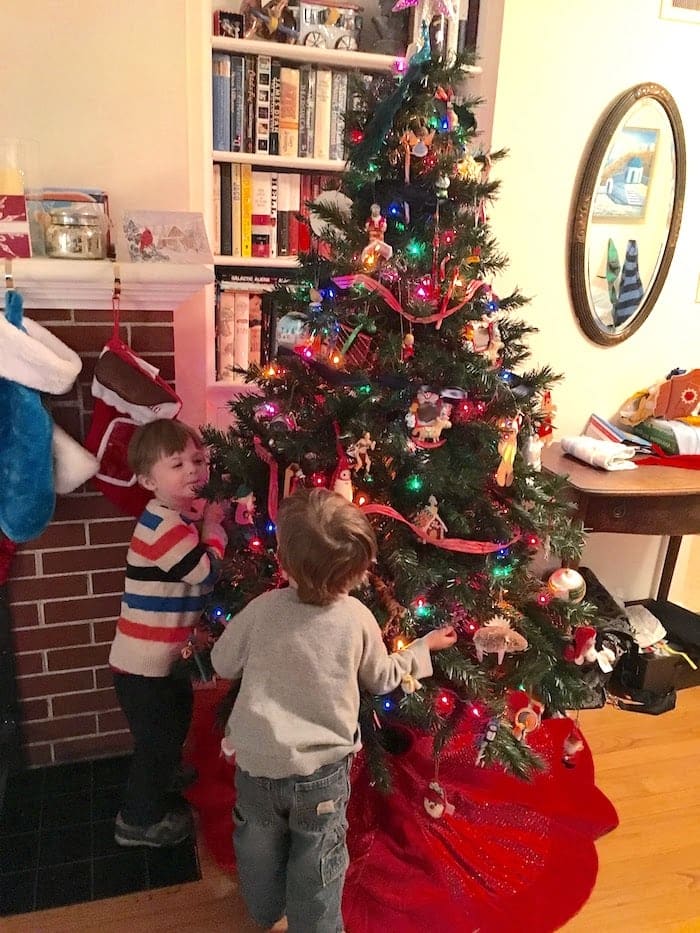 holiday safety tips kids looking at a Christmas tree