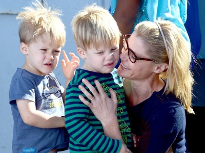 celebrities with twins Julie Bowen smiling at her young twin boys