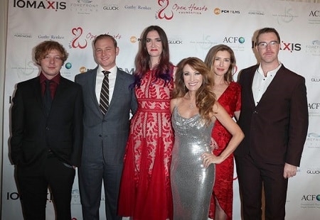 celebrities with twins Jane Seymour with her 5 adult children around her at a charity even posing and smiling for the camera