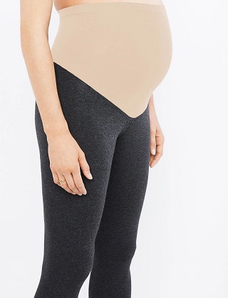 maternity leggings a pregnant woman wearing grey leggings with a nude colored waist covering her belly