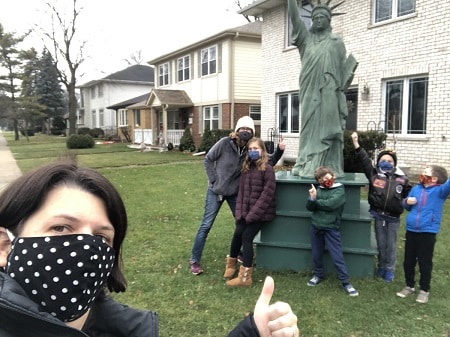 higlights of 2020 a masked woman taking a selfie with a group of masked children in front of a statue