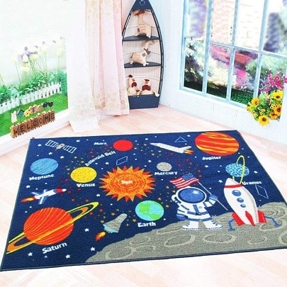 space themed nursery a rug with labelled planets and a rocket and astronaut on the moon.