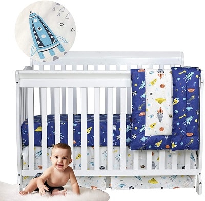 space themed nursery a baby in a room with a space themed crib