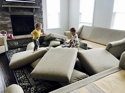 indoor physical activities little kids jumping on couch cushions