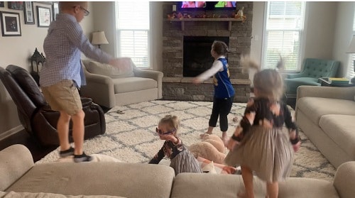 indoor physical activities 4 young kids jumping and dancing around a living room