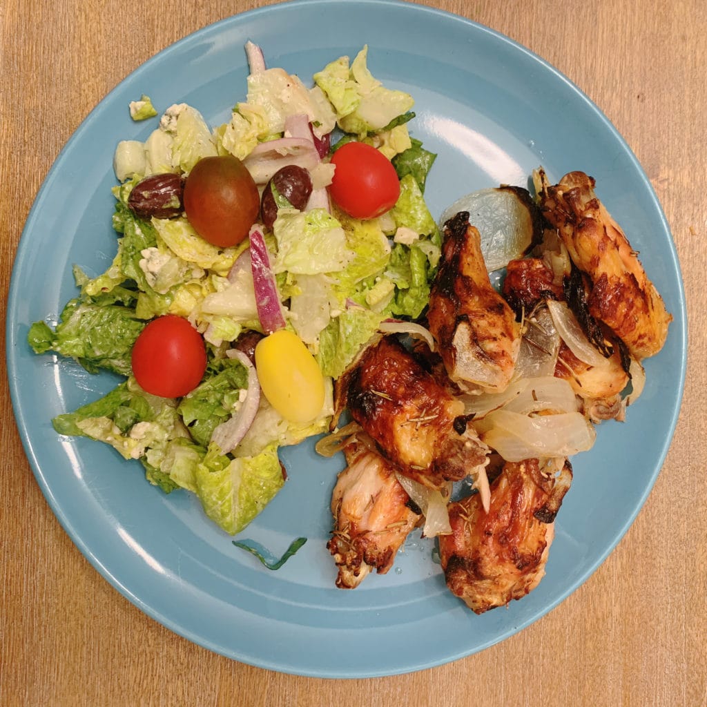 plated chicken wings with salad